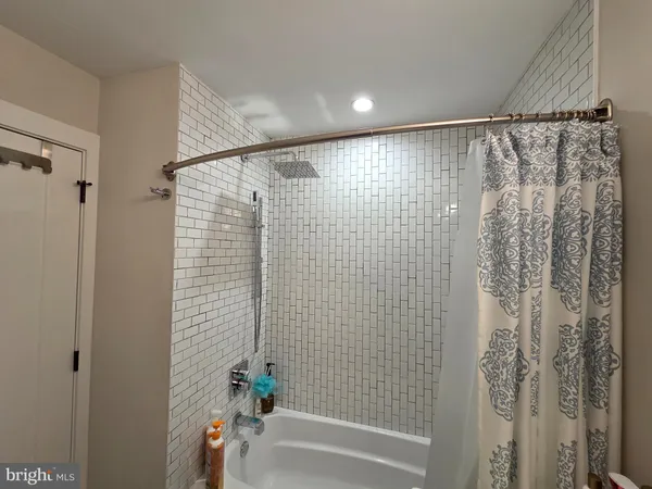 a bathroom with a shower curtain and a shower curtain