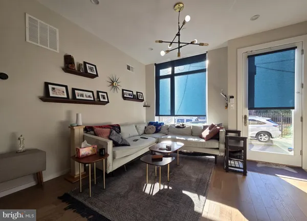 a living room with furniture and a chandelier