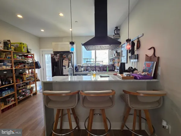 a kitchen with a dining table chairs and a chandelier