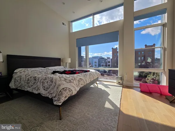 a bedroom with a bed couch and window