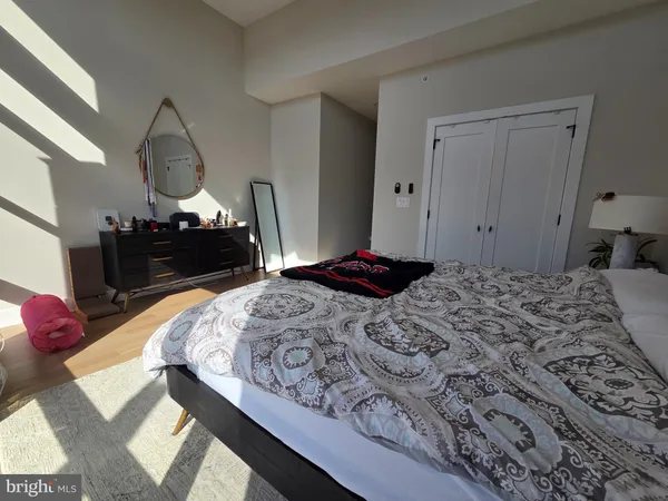 a bedroom with a bed dresser and a window