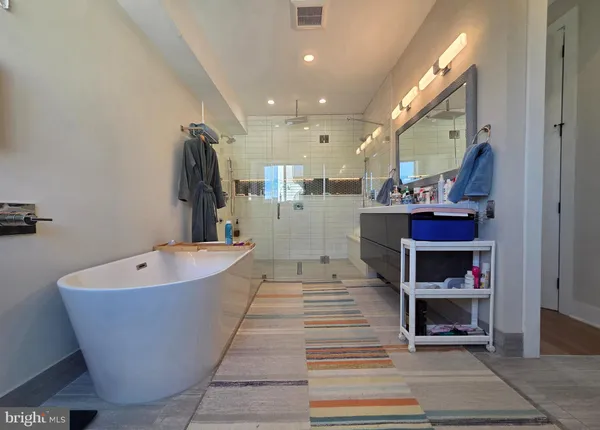 a dining room with kitchen island a chandelier and living room view