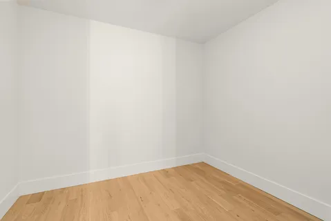 a view of a living room with furniture and wooden floor