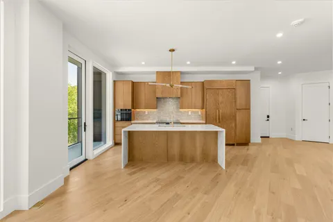 a large kitchen with stainless steel appliances granite countertop a granite counter tops and a window