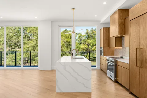 a large white kitchen with a large window