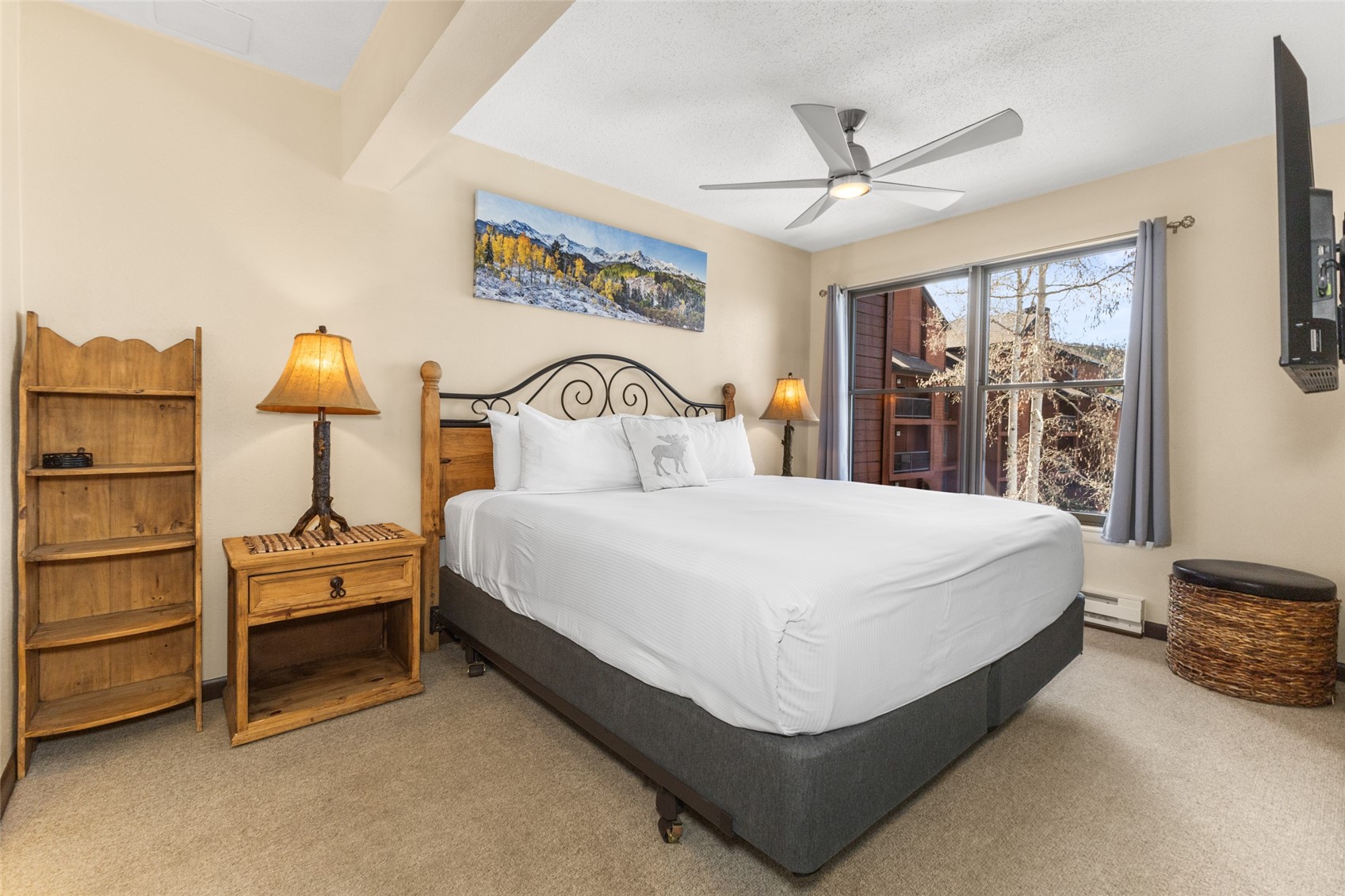2025 Walton Creek Road, Unit 308 Steamboat Springs, CO 80487 - Photo 11 of 34 a bedroom with a bed and a chandelier