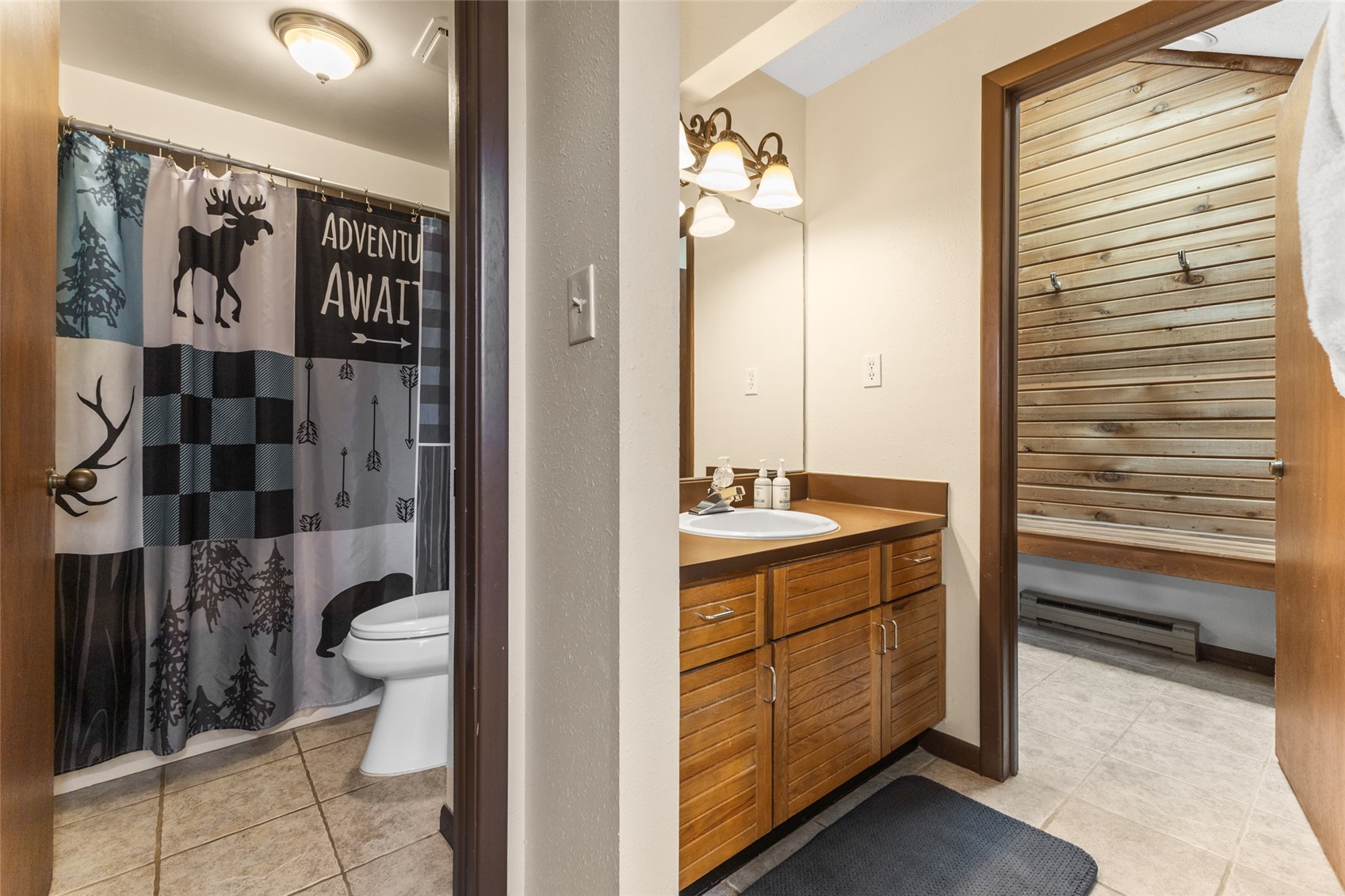 2025 Walton Creek Road, Unit 308 Steamboat Springs, CO 80487 - Photo 12 of 34 a bathroom with a granite countertop sink toilet and shower
