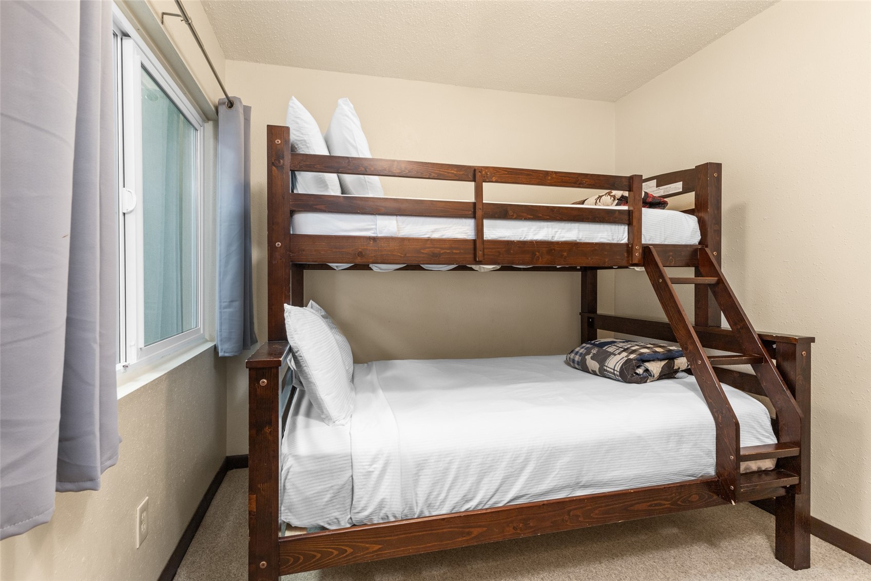 2025 Walton Creek Road, Unit 308 Steamboat Springs, CO 80487 - Photo 14 of 34 a bedroom with a bed and a window