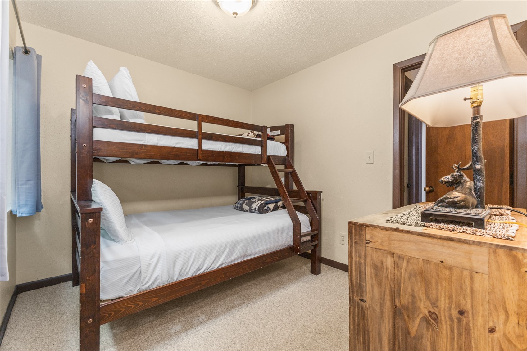 2025 Walton Creek Road, Unit 308 Steamboat Springs, CO 80487 - Photo 15 of 34 a bedroom with a bed and a table