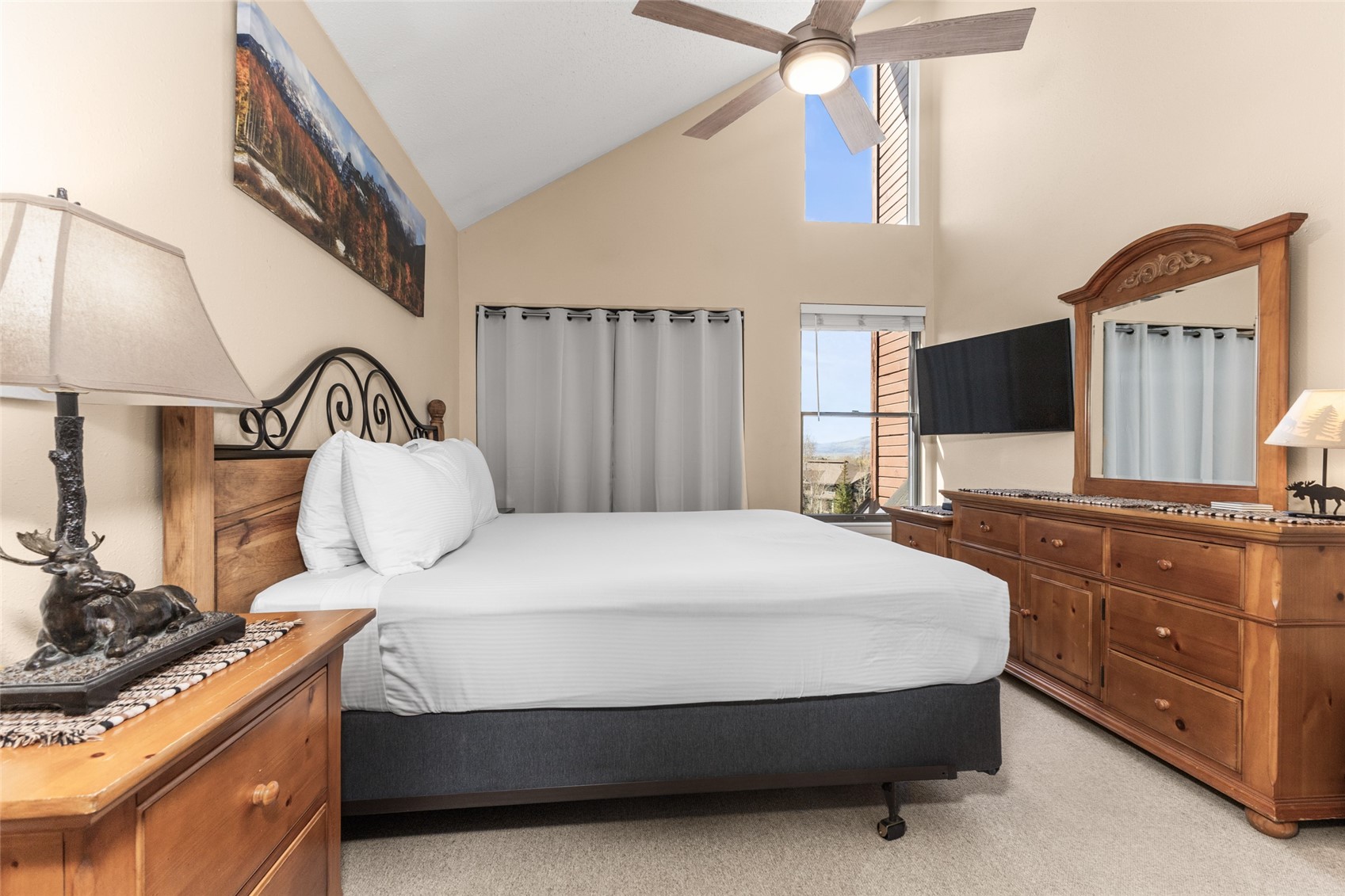 2025 Walton Creek Road, Unit 308 Steamboat Springs, CO 80487 - Photo 19 of 34 a bedroom with a large bed and a flat tv screen on dresser