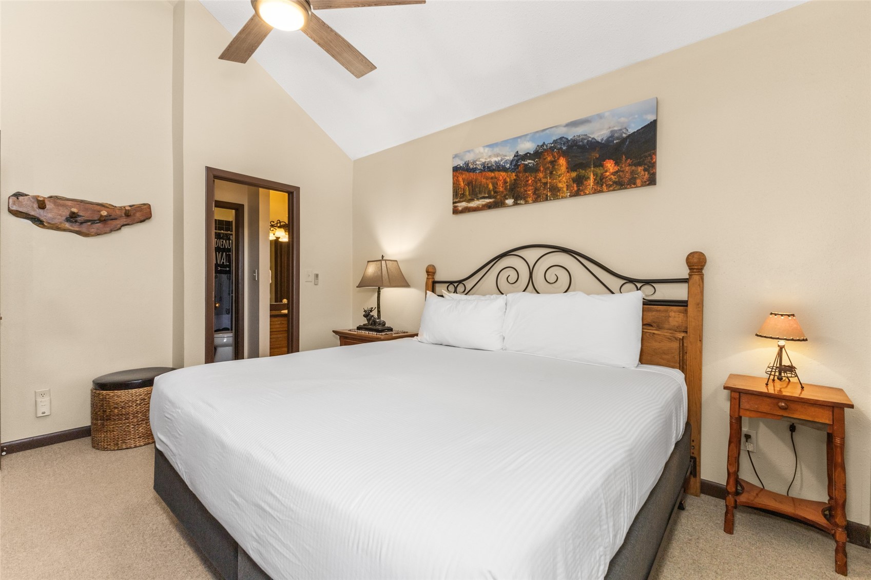 2025 Walton Creek Road, Unit 308 Steamboat Springs, CO 80487 - Photo 20 of 34 a bedroom with a bed and a lamp with the dresser