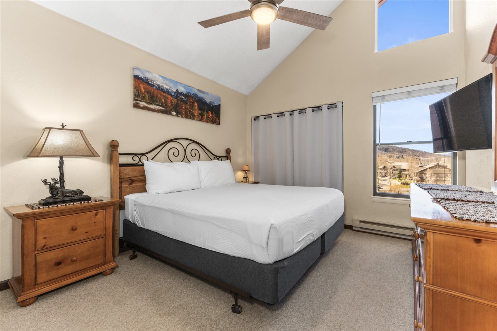 2025 Walton Creek Road, Unit 308 Steamboat Springs, CO 80487 - Photo 21 of 34 a bedroom with a bed and a chandelier