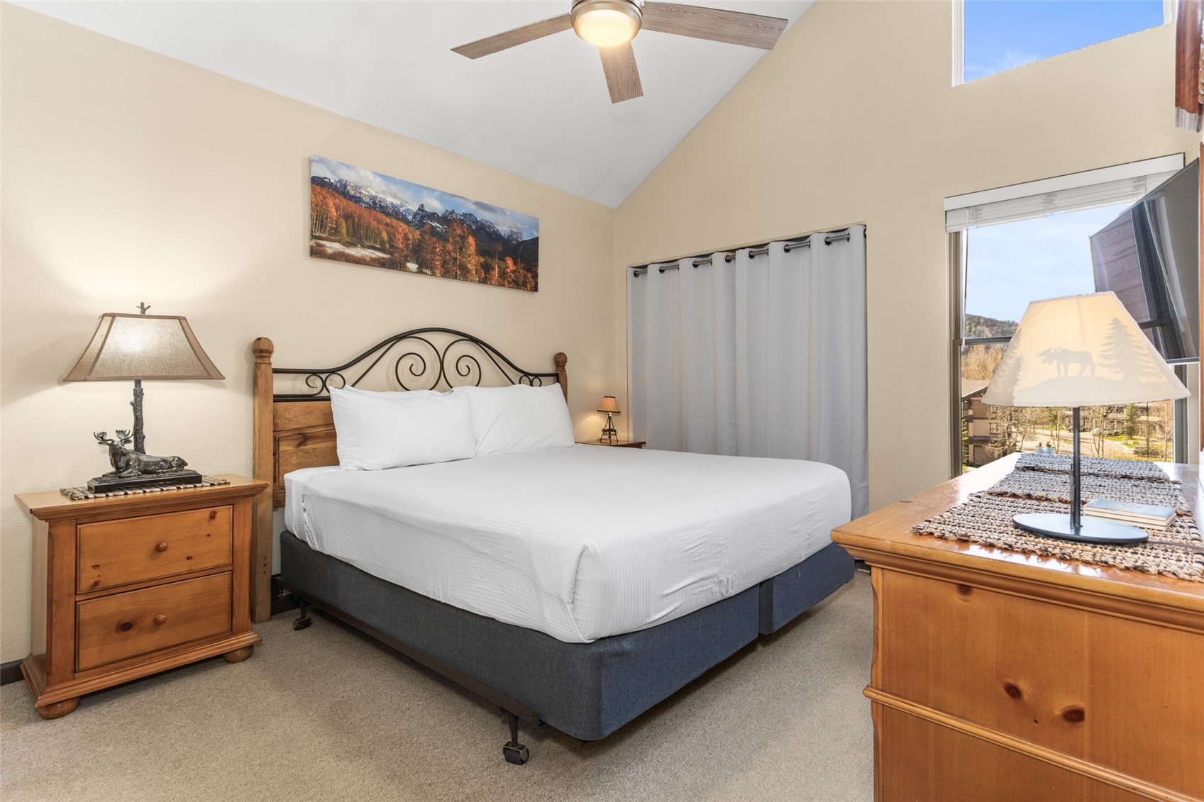 2025 Walton Creek Road, Unit 308 Steamboat Springs, CO 80487 - Photo 22 of 34 a bedroom with a bed and a lamp on the dresser
