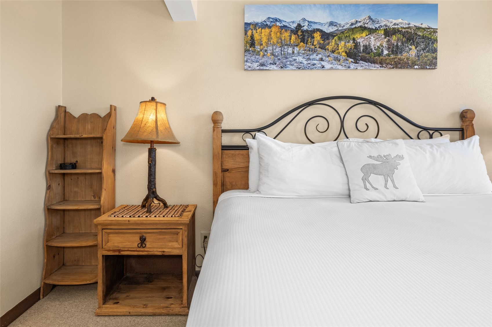 2025 Walton Creek Road, Unit 308 Steamboat Springs, CO 80487 - Photo 23 of 34 a bedroom with a bed and a lamp on dresser