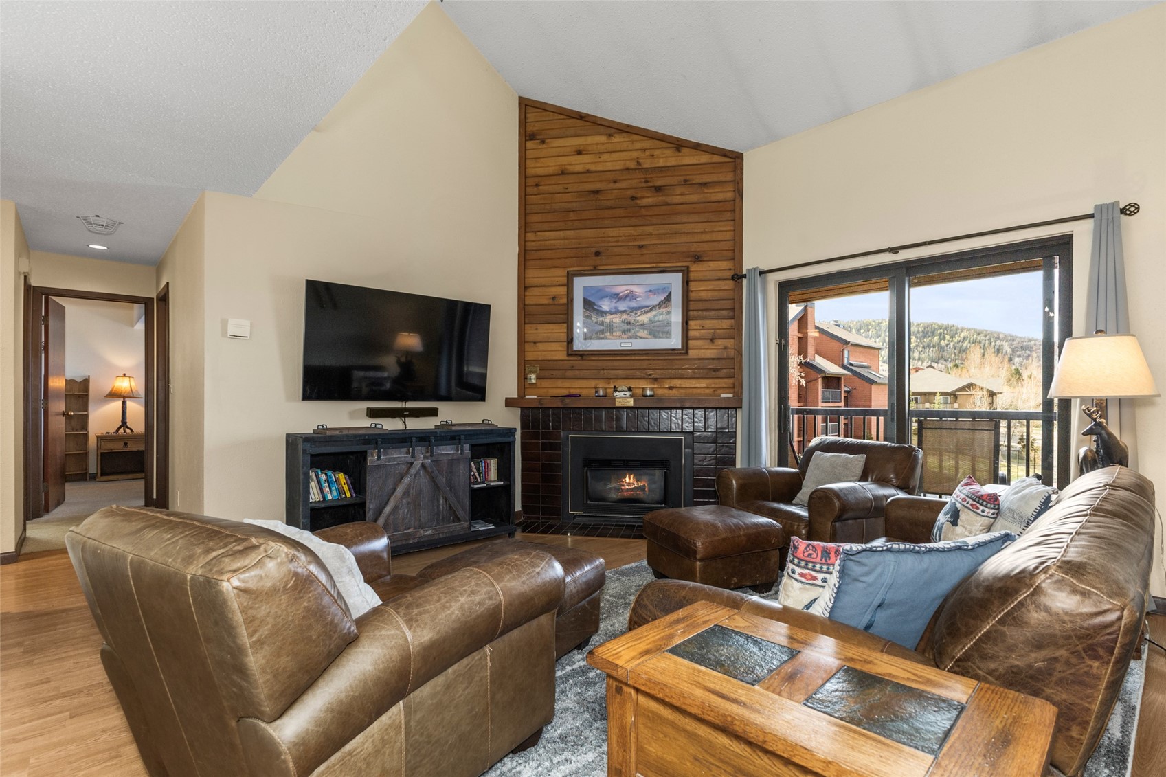 2025 Walton Creek Road, Unit 308 Steamboat Springs, CO 80487 - Photo 3 of 34 a living room with furniture a flat screen tv and a fireplace
