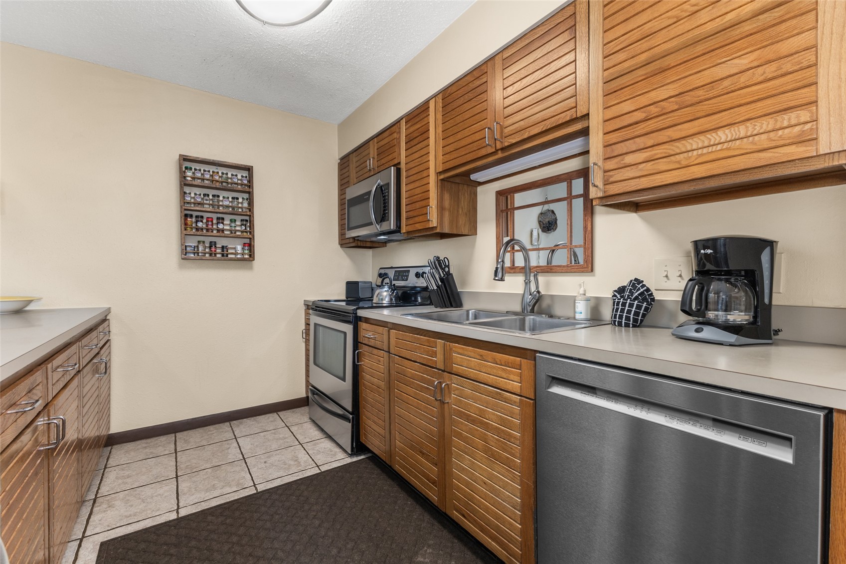 2025 Walton Creek Road, Unit 308 Steamboat Springs, CO 80487 - Photo 8 of 34 a kitchen with stainless steel appliances a sink stove and cabinets