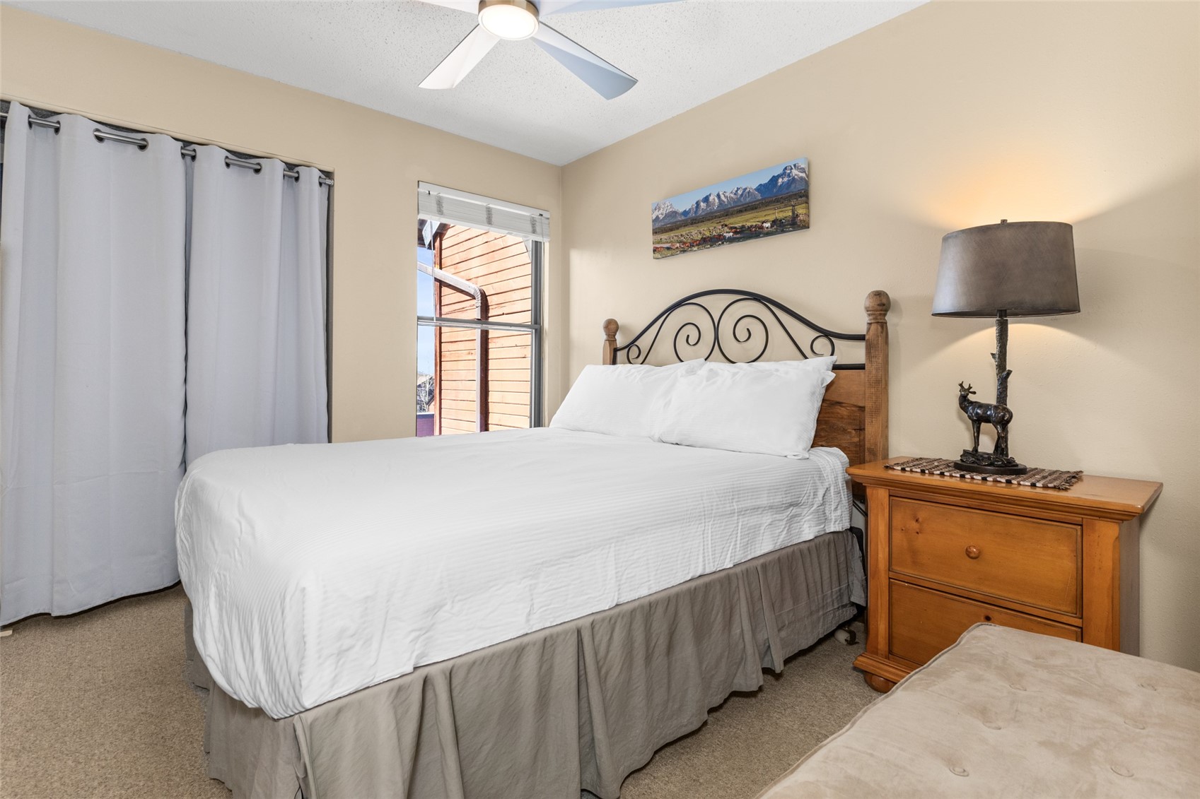 2025 Walton Creek Road, Unit 308 Steamboat Springs, CO 80487 - Photo 10 of 34 a bedroom with a bed and a night stand