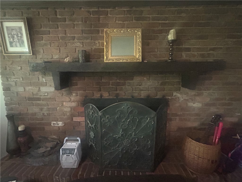 418 Saluda Road Williamston, SC 29697 - Photo 16 of 40 A robust brick fireplace offers a cozy focal point, perfect for gatherings.