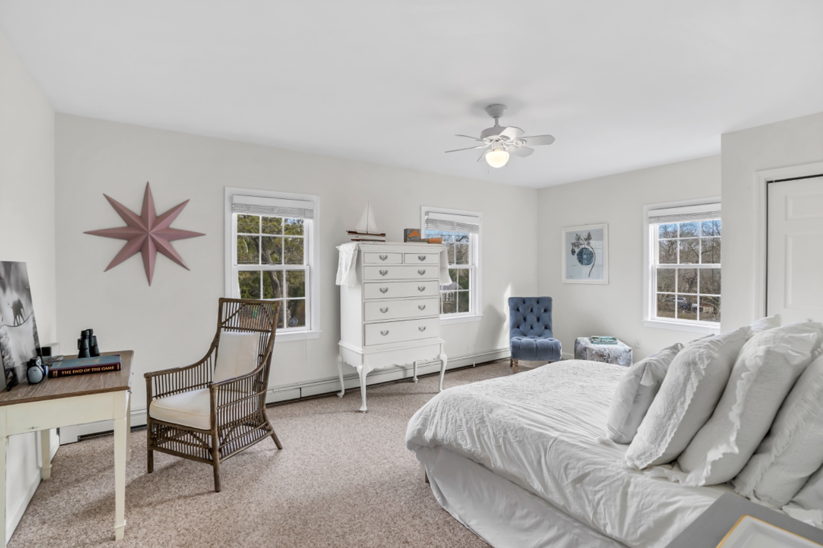 54 Lake Street Vineyard Haven, MA 02568 - Photo 12 of 30 a spacious bedroom with a bed a table and chair