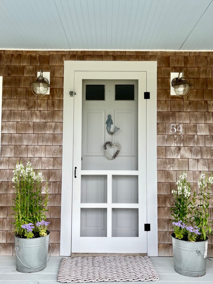 54 Lake Street Vineyard Haven, MA 02568 - Photo 4 of 30 a white vase with flowers on it