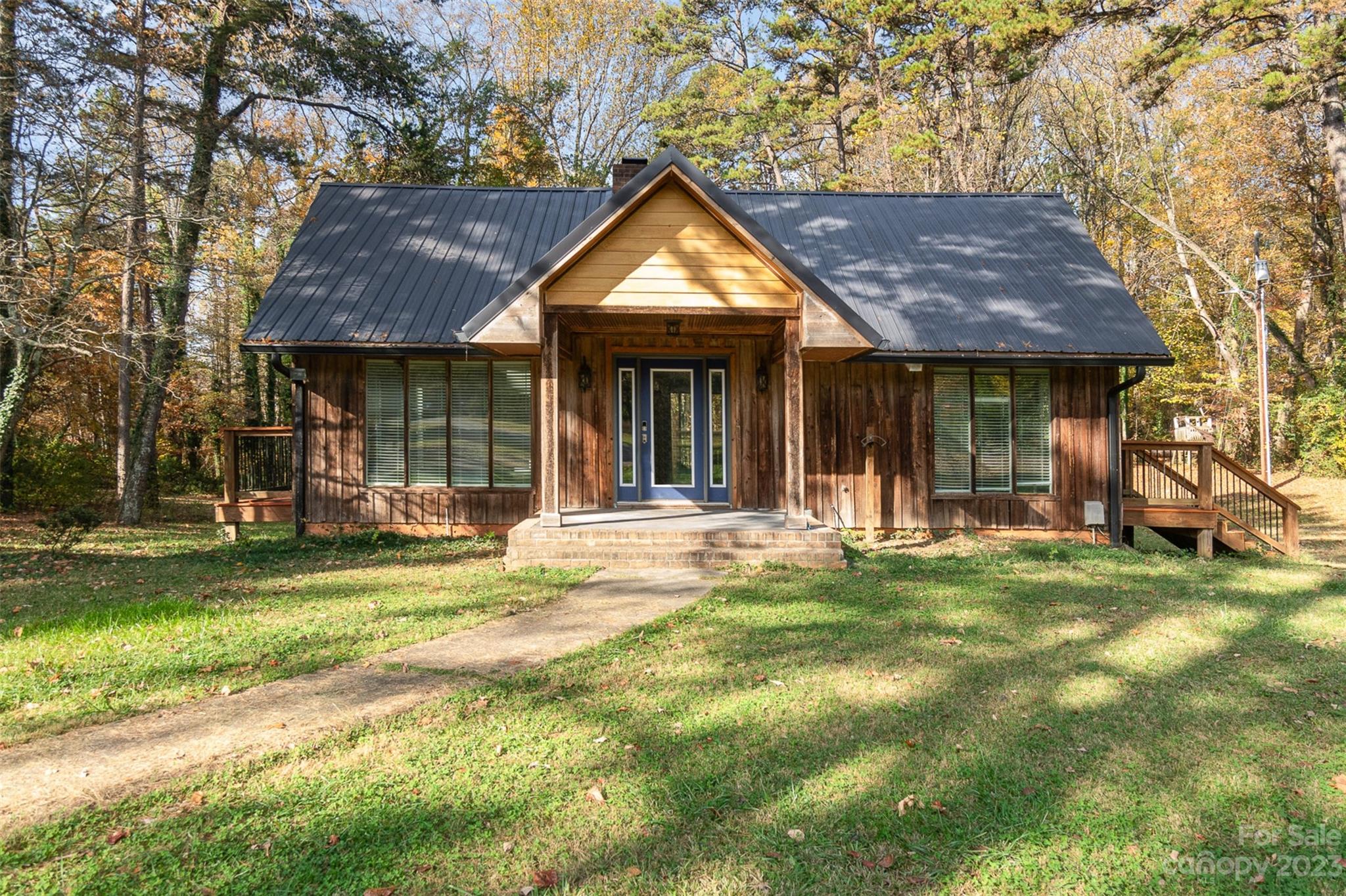 6745 Alanbrook Road Charlotte, NC 28215 - Photo 26 of 28 a front view of a house with a yard table and chairs