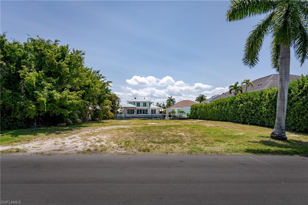 2165 Tarpon Road Naples, FL 34102 - Photo 4 of 24 a view of a yard with a house in the background