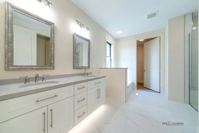 a spacious bathroom with a double vanity sink mirror and
