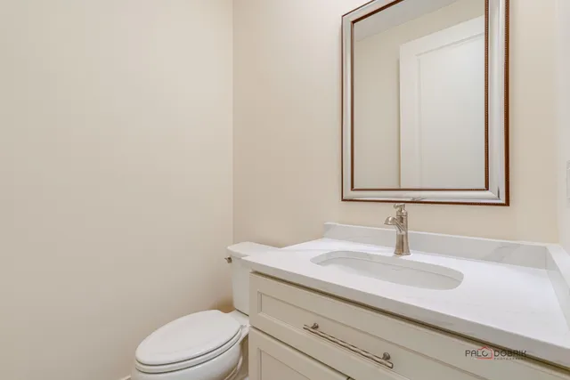 a bathroom with a sink toilet and mirror