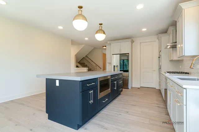 a kitchen with stainless steel appliances granite countertop a stove and a sink