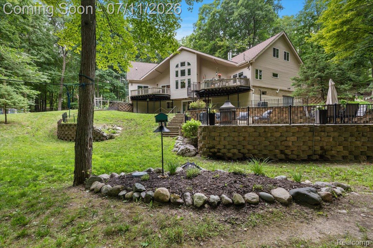 4219 Gardner Road Metamora, MI 48455 - Photo 5 of 87 Multi-level exterior with a large deck, lower patio, and extensive retaining walls