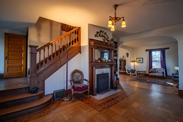 a bedroom with a bed and a window with wooden floor