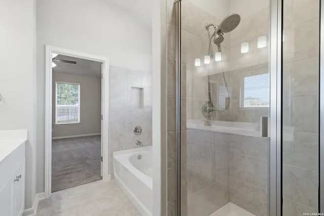 a bathroom with a bathtub shower and sink