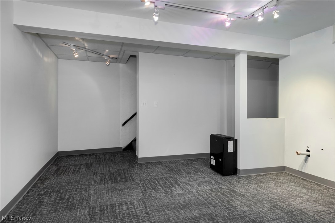 6484 State Road Parma, OH 44134 - Photo 29 of 36 Bright recreation room featuring track lighting and comfortable carpeting.
