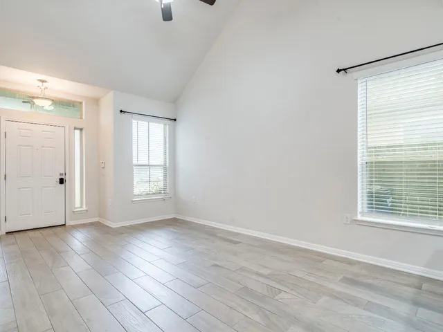 a kitchen with granite countertop a sink stove and microwave