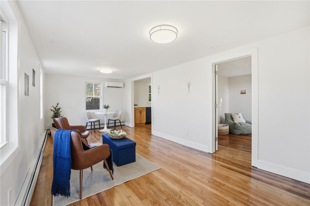 207 Mendon Road Cumberland, RI 02864 - Photo 4 of 22 Living/Dining room with beautifully refinished hardwoods and LED lighting