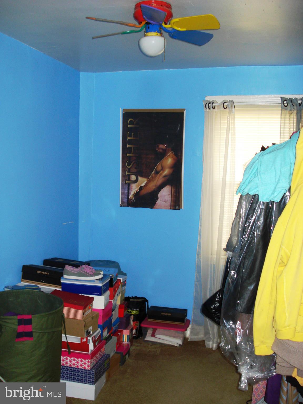 3906 Flowerton Road Baltimore, MD 21229 - Photo 22 of 27 a bedroom with a bed and a chandelier