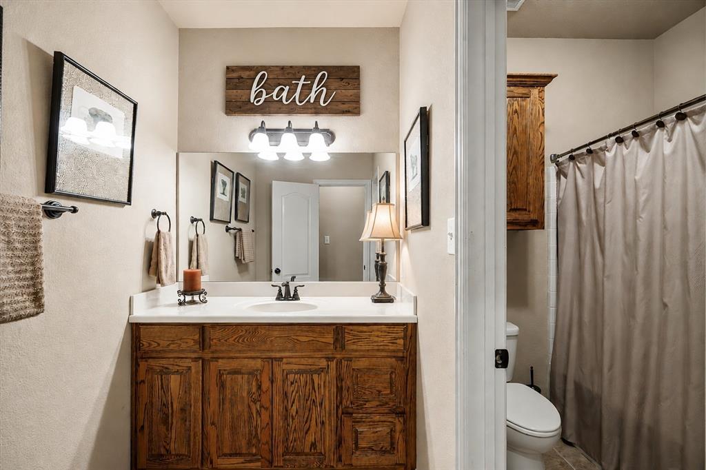 1852 Meadowview Canton, TX 75103 - Photo 20 of 28 a bathroom with a double vanity sink mirror and toilet