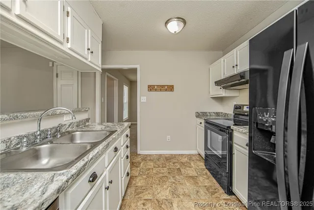 a utility room with cabinets washer and dryer