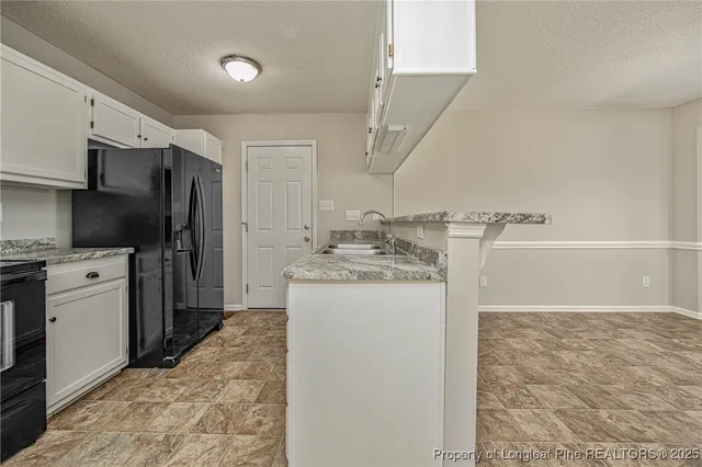 a view of a kitchen with wooden floor