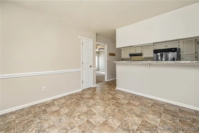 a view of an empty room with a fan