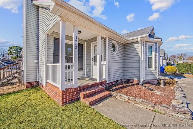 a backyard of a house with barbeque oven table and chairs