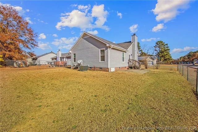 a view of a house with pool and chairs
