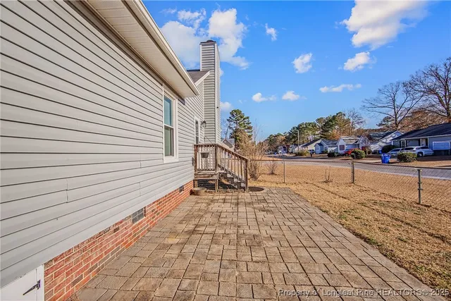a swimming pool with outdoor seating and yard