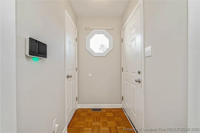 an empty room with a fireplace and a window