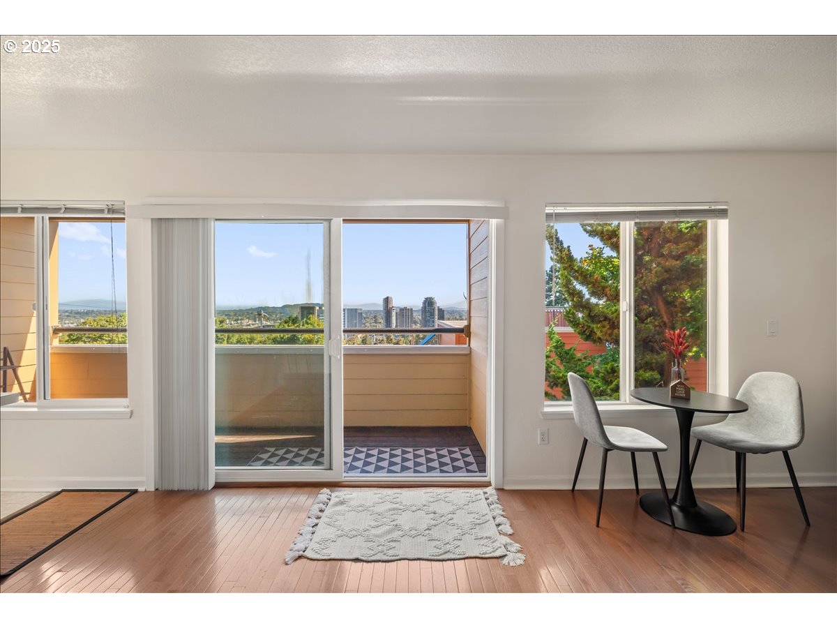 3515 Southwest Barbur Boulevard, Unit P1 Portland, OR 97239 - Photo 11 of 35 a living room with furniture and a window