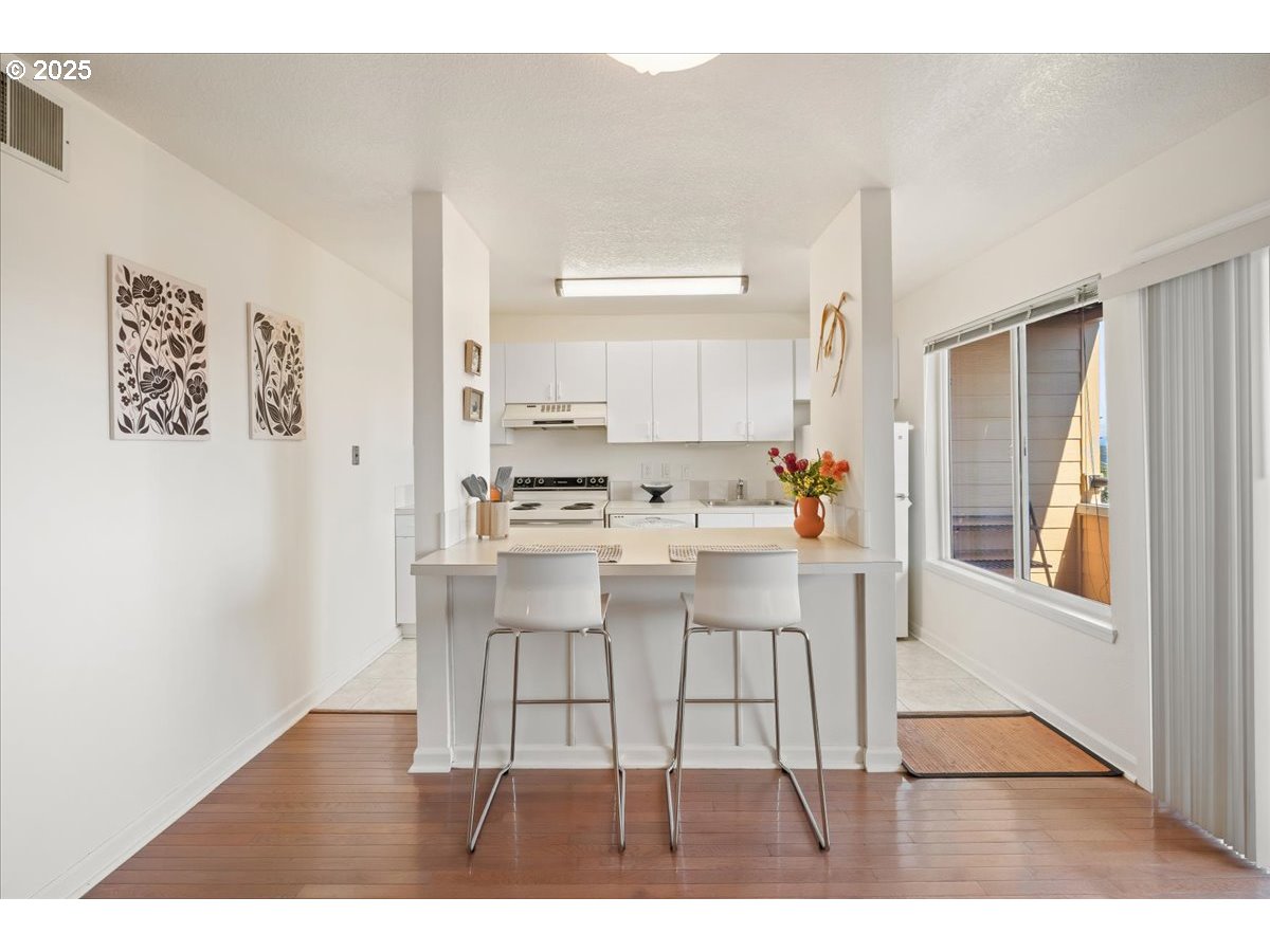 3515 Southwest Barbur Boulevard, Unit P1 Portland, OR 97239 - Photo 12 of 35 a dining room with furniture and window