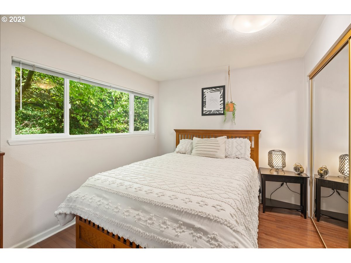 3515 Southwest Barbur Boulevard, Unit P1 Portland, OR 97239 - Photo 16 of 35 a bedroom with a bed and a window
