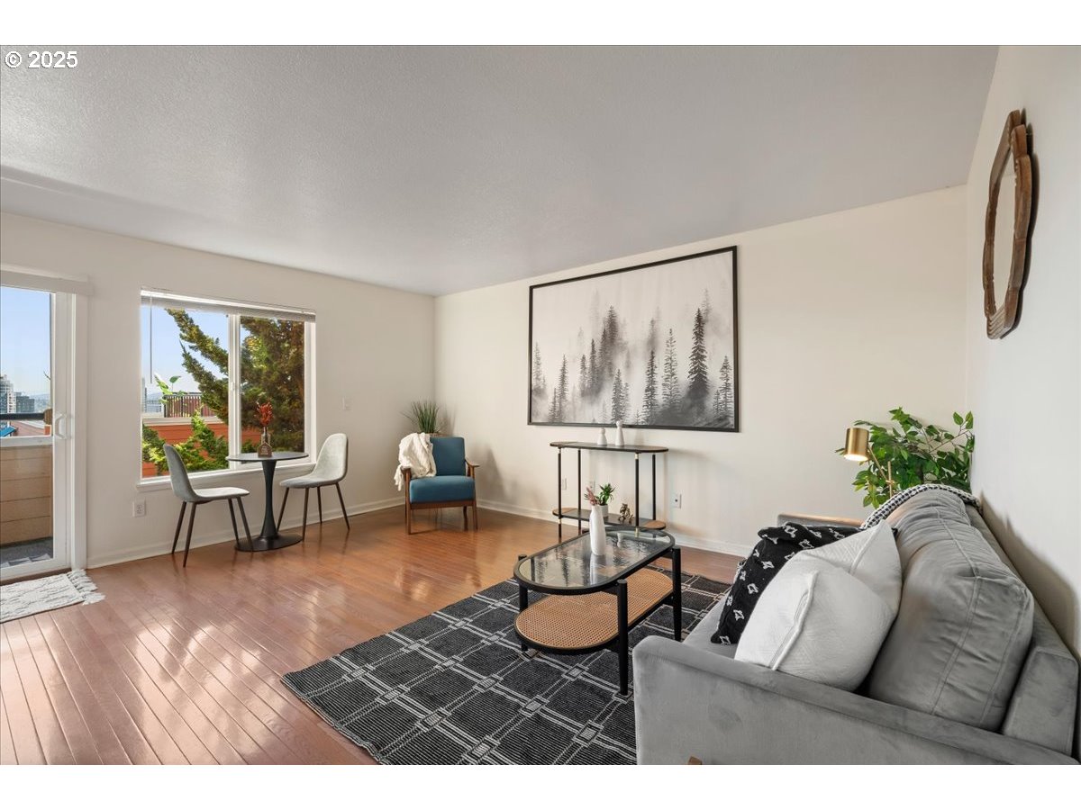 3515 Southwest Barbur Boulevard, Unit P1 Portland, OR 97239 - Photo 5 of 35 a living room with furniture and a window