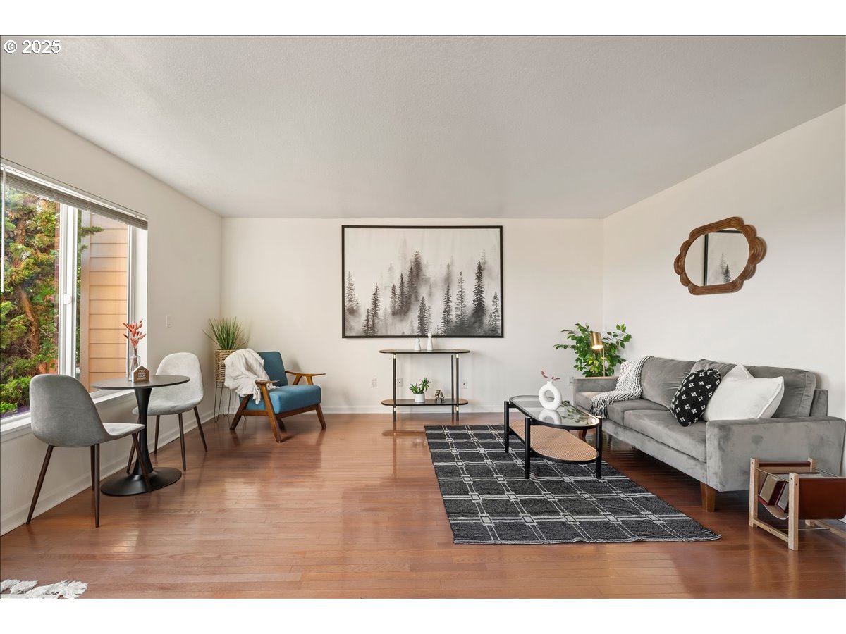 3515 Southwest Barbur Boulevard, Unit P1 Portland, OR 97239 - Photo 6 of 35 a living room with furniture and a wooden floor
