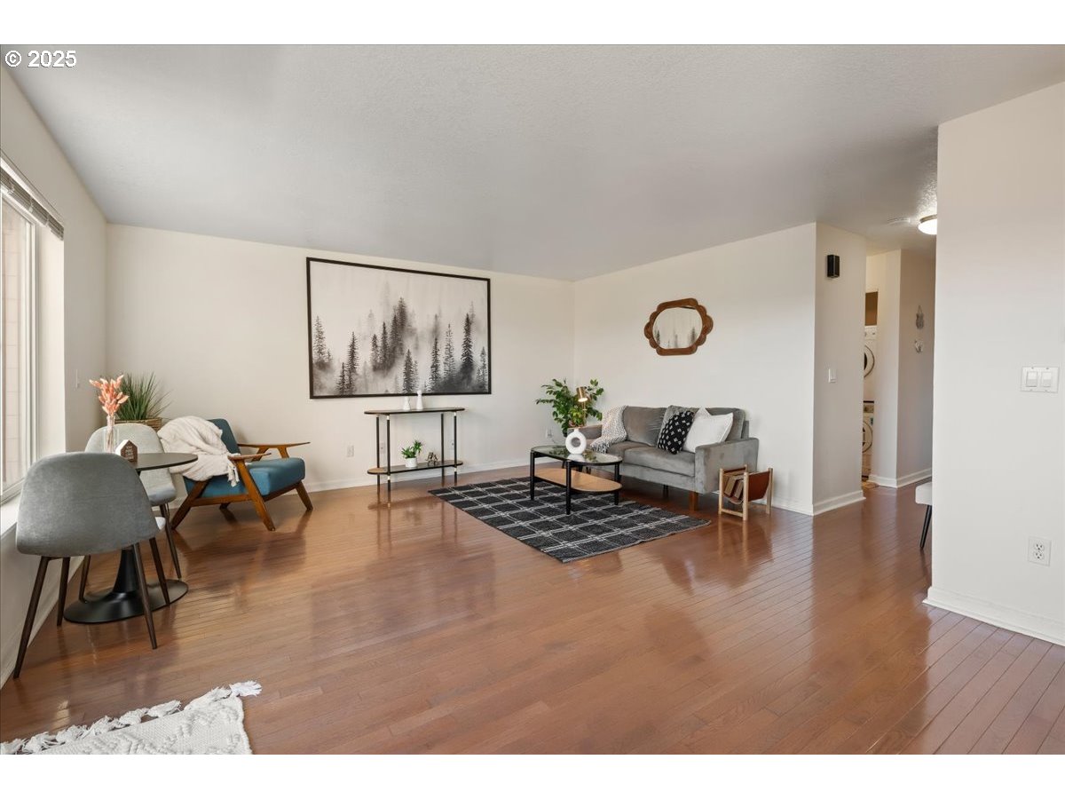 3515 Southwest Barbur Boulevard, Unit P1 Portland, OR 97239 - Photo 7 of 35 a living room with furniture and wooden floor